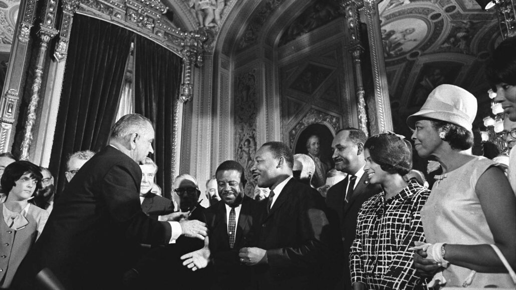 President Lyndon Johnson shakes hands with civil rights activists, including Dr. Martin Luther King Jr., after signing the Voting Rights Act of 1965. (Photo courtesy the LBJ Presidential Library)